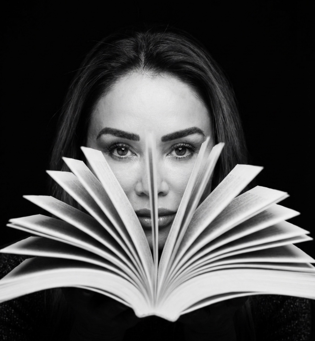 Dr. Nadja Giuffrida looking through the pages of an open book